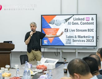 a man standing in front of a large screen
