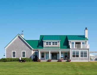 a photo of an east coast home with a green metal roof