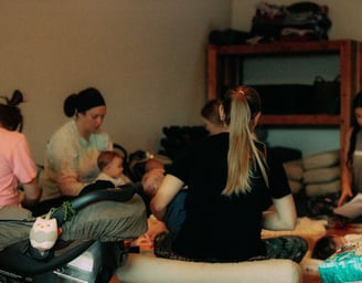 A group of mothers in a yoga studio with their babies