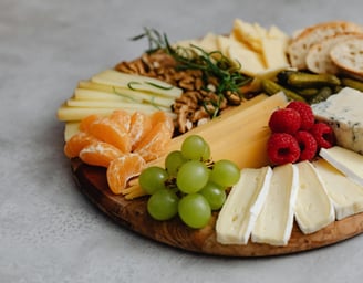 a platter of cheeses and fruit