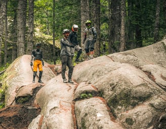 coach teaching a group of people riding on a mountain bike