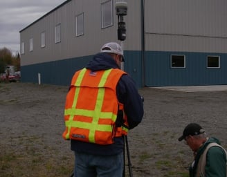 a man in a safety vest and a camera