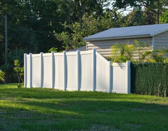 a fenced in area with a fence and a motorcycle