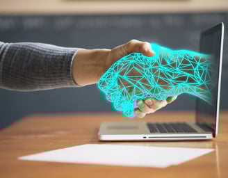 a person shaking hands with a laptop