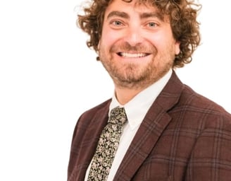 Ari Malman, Denver Attorney; a man in a suit and tie smiling
