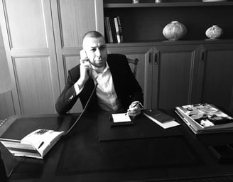a man in a suit and tie is talking on the phone