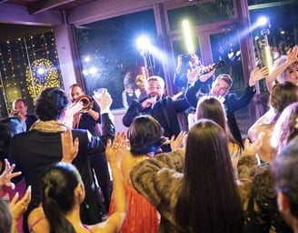 Wedding band interacting with dancing guests during a live show