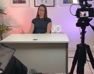 a woman sitting at a desk working on content creation