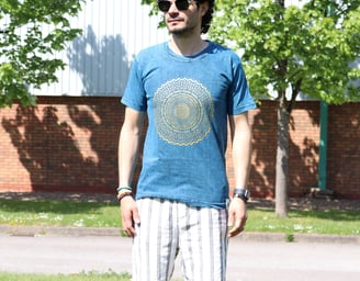 a man standing on a skateboard in the grass