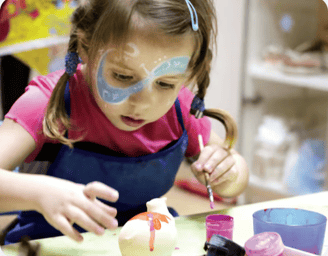a small kid painting