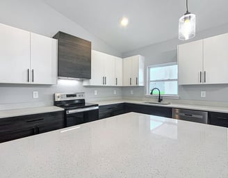 Modern kitchen renovation with quartz countertops, shaker cabinets, and recessed lighting installed