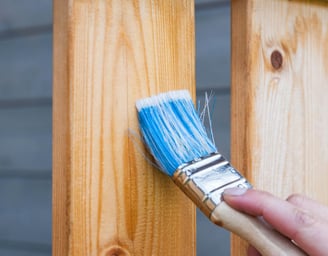 Exterior house painting transformation with weatherproof coatings and modern color scheme applied by