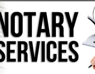 a person holding a pen and writing a note pad advertising notary services