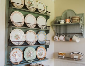 a kitchen with a peg rail shelf with plates and bowls