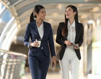 2 women walking in a building
