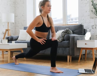 a woman in a black bra top and black bra top exercising