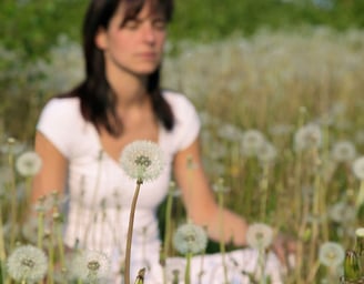 woman sitting in a field in silence