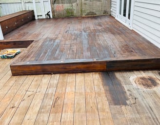 a wooden deck with a bench and a bench