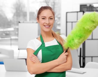 a woman in green aprons holding a green duster