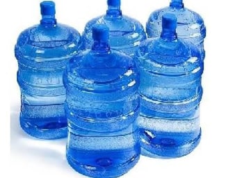 a group of three large water bottles with water in them