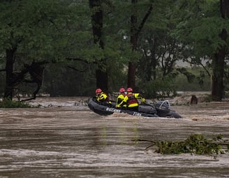 COMFORT, TEXAS – JULY 04: Boerne Search and Rescue teams navigate upstream in an inflatable boat on