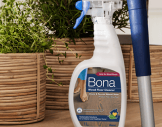 a spray bottle of bona cleaner on a wooden table