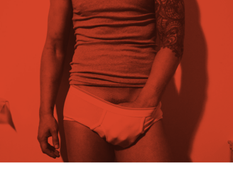Toronto Gay Escort & Nude Male Massage by Nick Rivera | A red filtered photo of Nick in white briefs