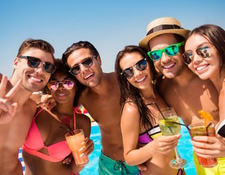 Group of friends enjoying drinks and sun during a Las Vegas private dayclub crawl with poolside fun.