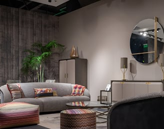 a living room with a couch and a round mirror