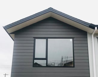 a house with a large window and a wooden table