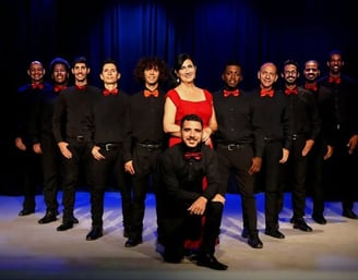 a group of people standing in front of a stage