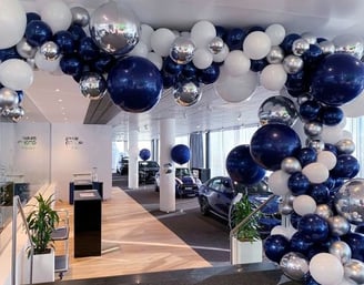 a car dealership with balloons and balloons