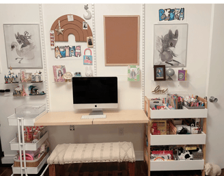 Organized kids’ study area with craft carts, art supplies, computer desk, and wall decor.