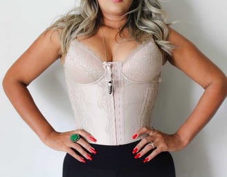 a woman in a white top and black pants