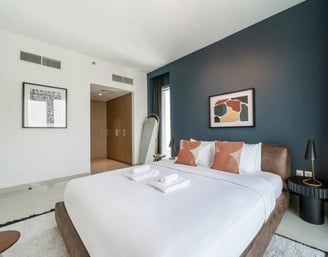 a bedroom with a bed and a mirror