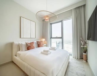 a bedroom with a bed and a television