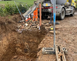 a cement mixer truck is parked in a ditch