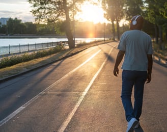 a man skateboarding down a street in the sun