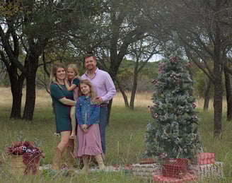 family with Christmas tree prop outdoor photo session near Dallas Fort Worth DFW area, Texas