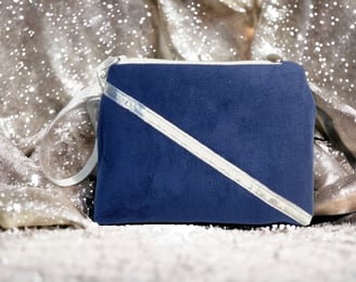 a blue bridsmaid purse with a white ribbon and a silver ribbon