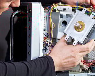 a man is fixing a computer monitor in a computer