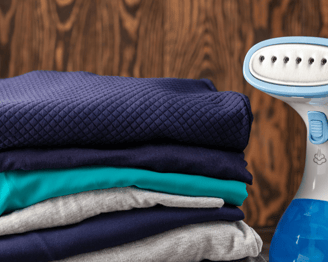 a pile of folded folded towels and a blue and white electric razor razor razor razor