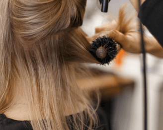 a woman is getting her hair styled with a hairdoodle