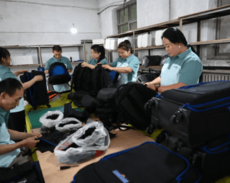 a group of people Do a quality check on the bag