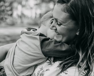 a woman holding a child in her arms