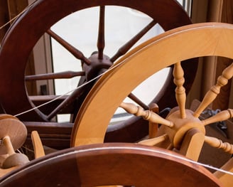 Spinning wheels lined up next to each other.