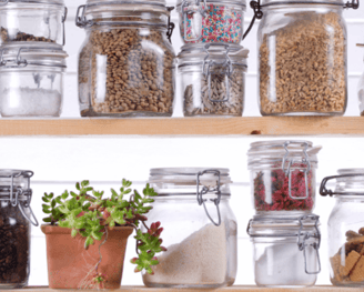 Rows of mason jars with food in them on a shelf.