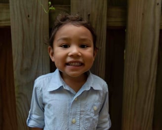 A young boy smiling at the camera.