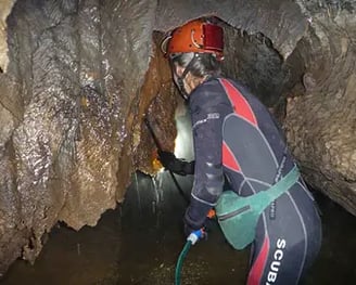 Clare Buswell cleaning cave formations after bushfires