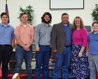 Dawson family standing in the front of the church